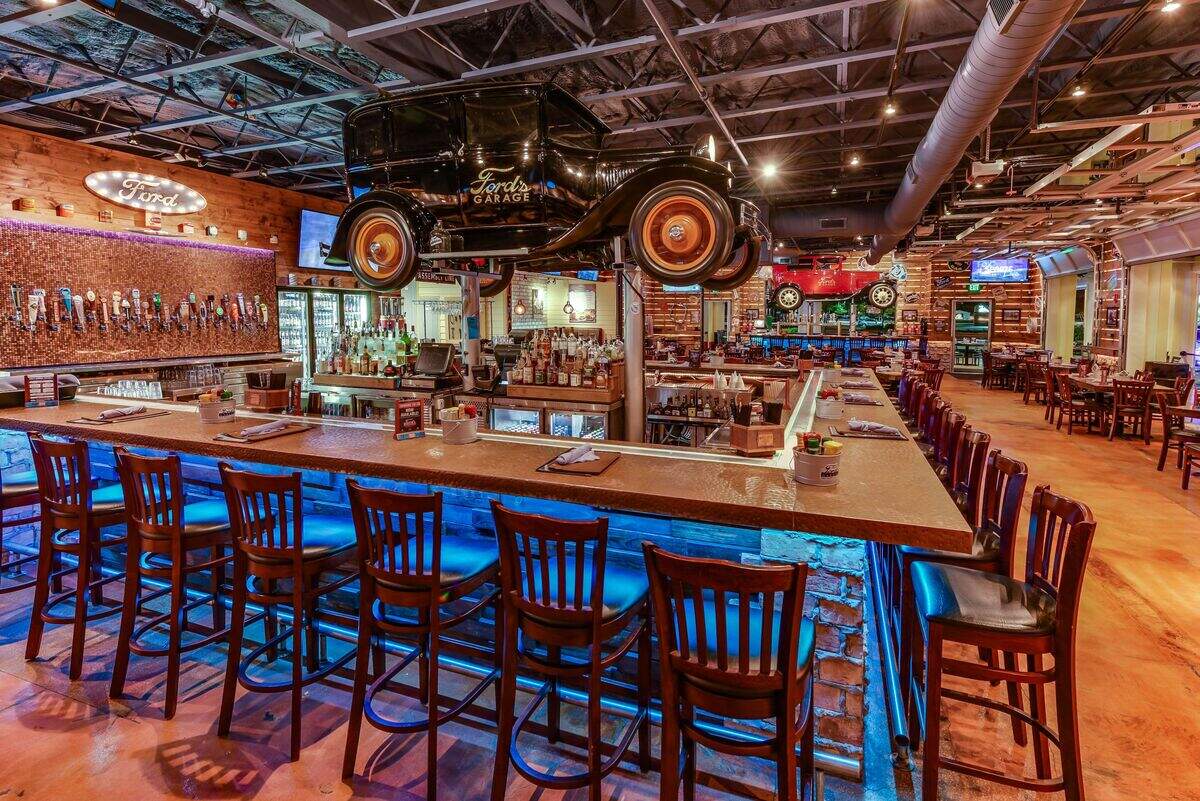 Ford’s Garage plans to open a 300-seat restaurant in University Town Center by the end of 2019. A trademark is the antique automobiles suspended above the bar.