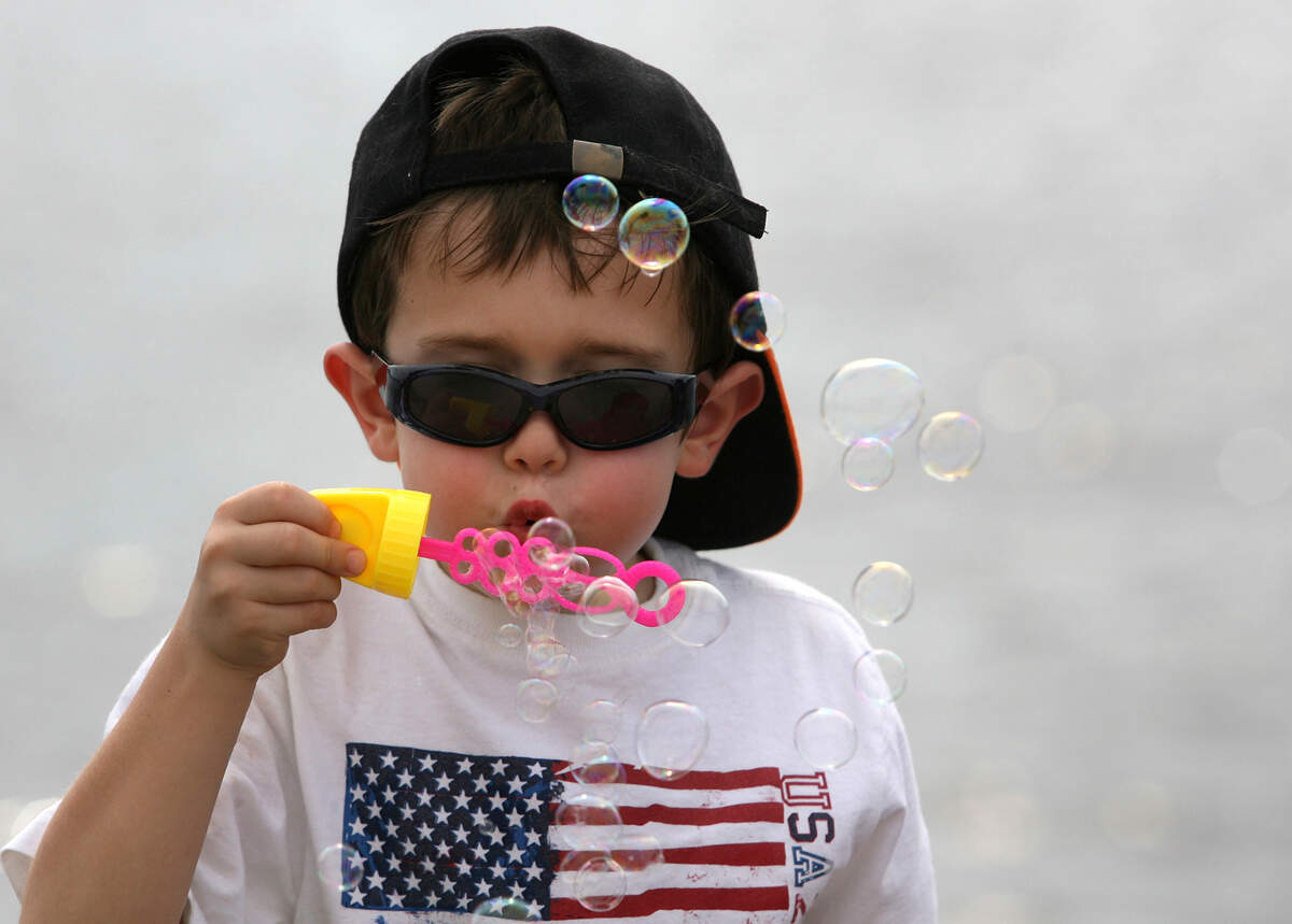 Thomas Gabriel blows bubbles in the breeze on Palmetto’s riverfront during the Fourth of July celebrations in this file photo.