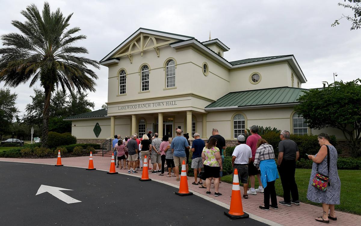 Voters line up outside the Lakewood Ranch Town Hall for the first day of early voting Wednesday morning.
