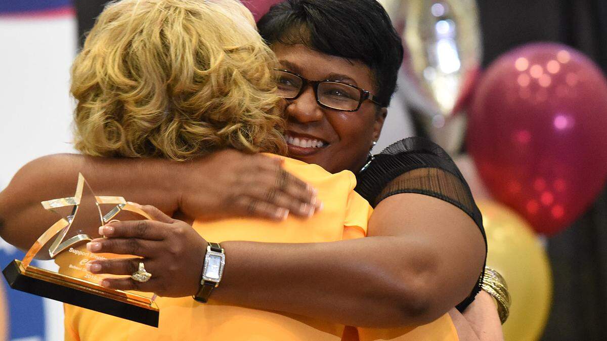 Diana Greene, Superintendent of Schools, hugs Support Employee of the Year winner Cheryl Smith at the Excellence in Education Awards at MTC on March 2, 2016. 
 TIFFANY TOMPKINS/Bradenton Herald