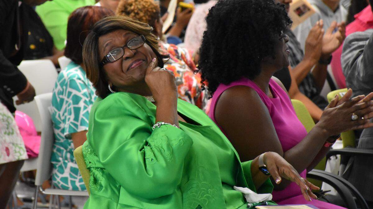 Barbara A. Harvey smiles as she listens to speakers share stories about her passion for educating children at Saturday’s dedication ceremony.