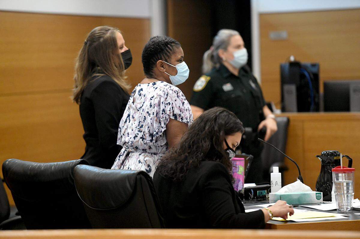 06/17/21—Roberta McDonald stands between her defense attorneys, Destiny Prater and Anne Hunter, as the jury enters the courtroom on Wednesday.