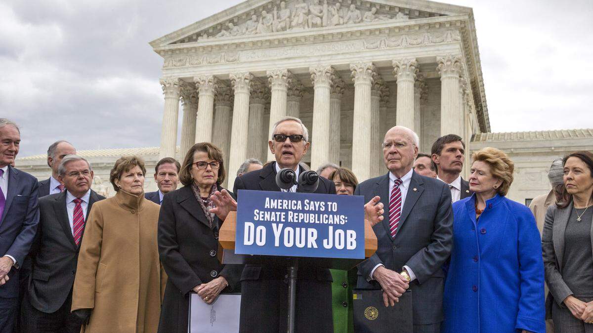Senate Minority Leader Harry Reid, D-Nev., center, joined at right by Sen. Patrick Leahy, D-Vt., the ranking member of the Senate Judiciary Committee, and other Democrats, urges Senate Republicans to relent on their decision to take no action on anyone President Barack Obama nominates to fill the Supreme Court vacancy created by the death of Justice Antonin Scalia, at the Supreme Court on Capitol Hill in Washington, Thursday, Feb. 25, 2016. (AP Photo/J. Scott Applewhite)