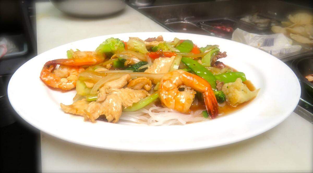 Combination stir fry -- shrimp, chicken, and beef -- over rice noodles at Demi’s Noodle House, 1318 10th St W, Palmetto.
