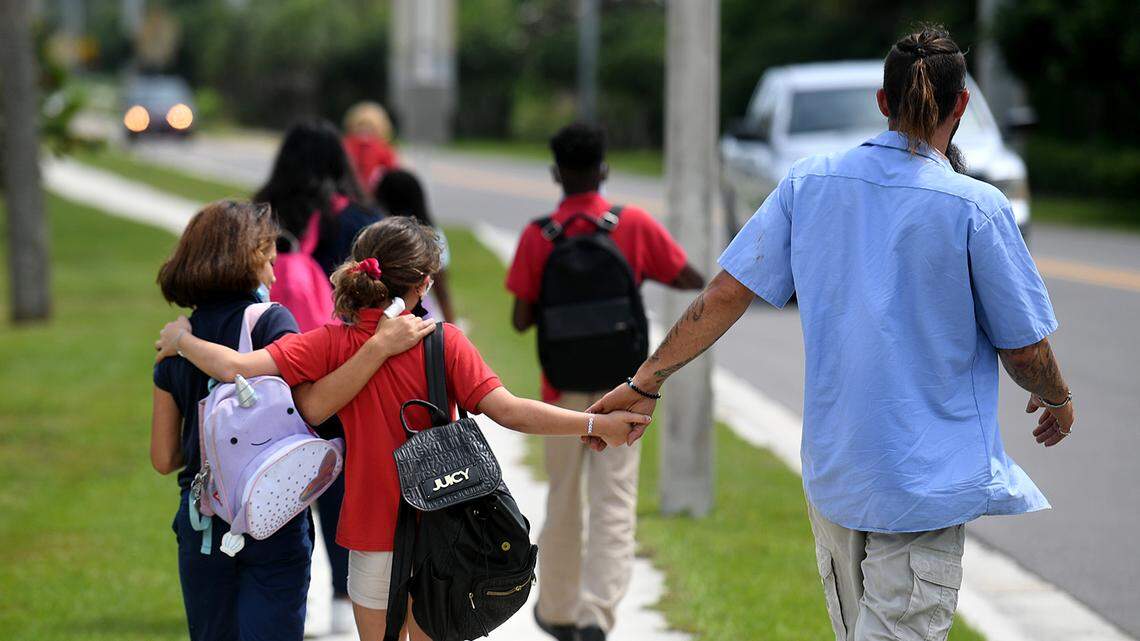 04/15/21-- Sea Breeze Elementary students walk home with family after school. Elementary students will have several hours of extra class time in the 2021-22 school year after a recent decision by the school board.