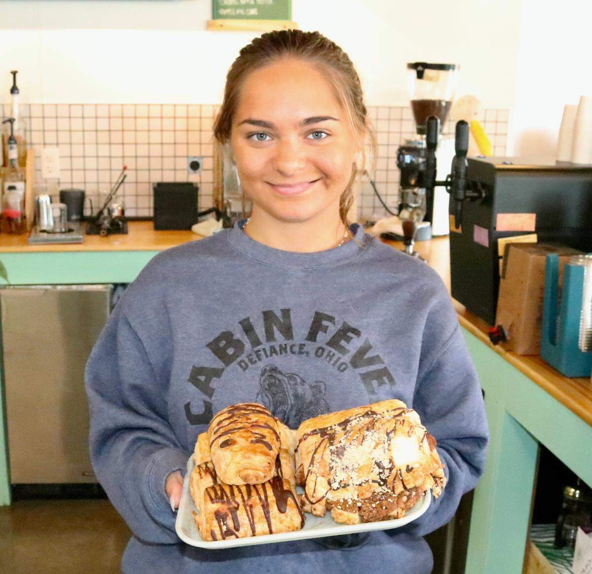Izabel Tracy is shown Nov. 18, 2022, with locally sourced pastry sold at Banyan Coffee Company, 1110 Tenth St. W., Palmetto.