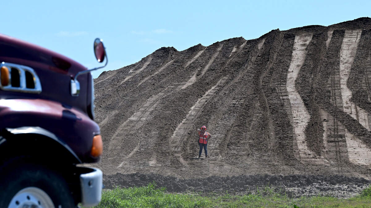 Massive mounds of dirt are transported up to the gypsum stacks as they close more ponds. Site operators at Piney Point hope to be in the final phase of closing the former phosphate plant, shown on April 15, 2026.