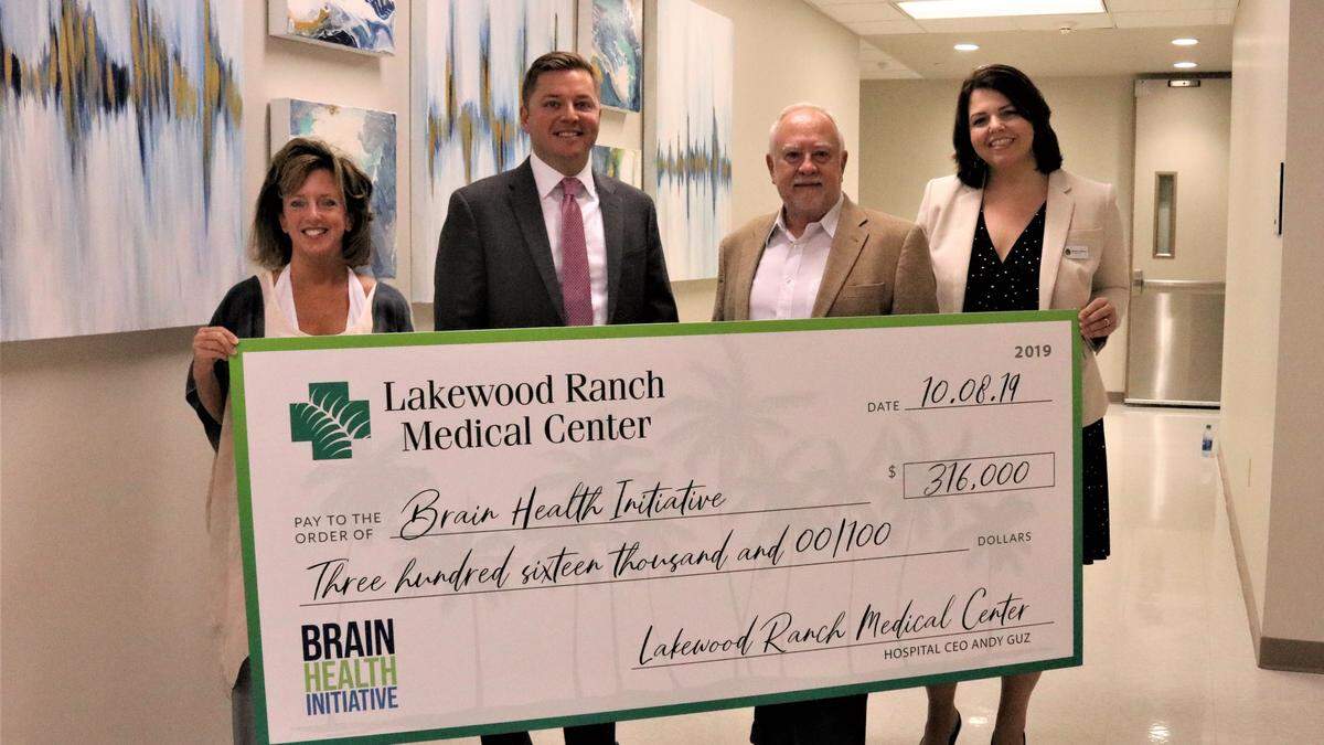 A $316,000 gift from Lakewood Ranch Medical Center helps the Brain Health Initiative stay on course for launching a pilot program in the spring. Shown above are, left, Stephanie Peabody, executive director, Andy Guz, hospital CEO, Rex Jensen, CEO of Schroeder-Manatee Ranch, and Monaca Onstad, director of community relations for LWR Communities.