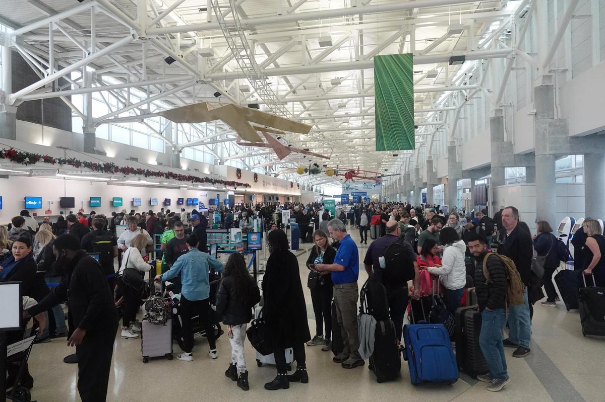 An hours-long line of passengers wait to check in Tuesday, Dec. 27, 2022, at Fort Lauderdale-Hollywood International Airport. A brutal winter storm has caused major delays in air travel across the U.S.
