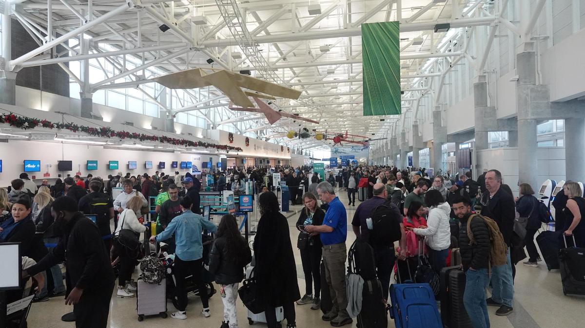 Passengers wait in an hours-long line to check in Tuesday, Dec. 27, 2022, at Fort Lauderdale-Hollywood International Airport. A brutal winter storm caused major delays in air travel across the U.S.