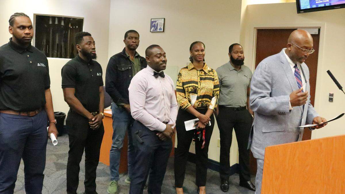 Reggie Bellamy, right, Manatee County commissioner, shown above May 10, 2022, presents a resolution recognizing the first Haitian Flag Day Festival, set for May 14 at Sutton Park in Palmetto. Standing with him are members of the Haitian Connection of Manasota.