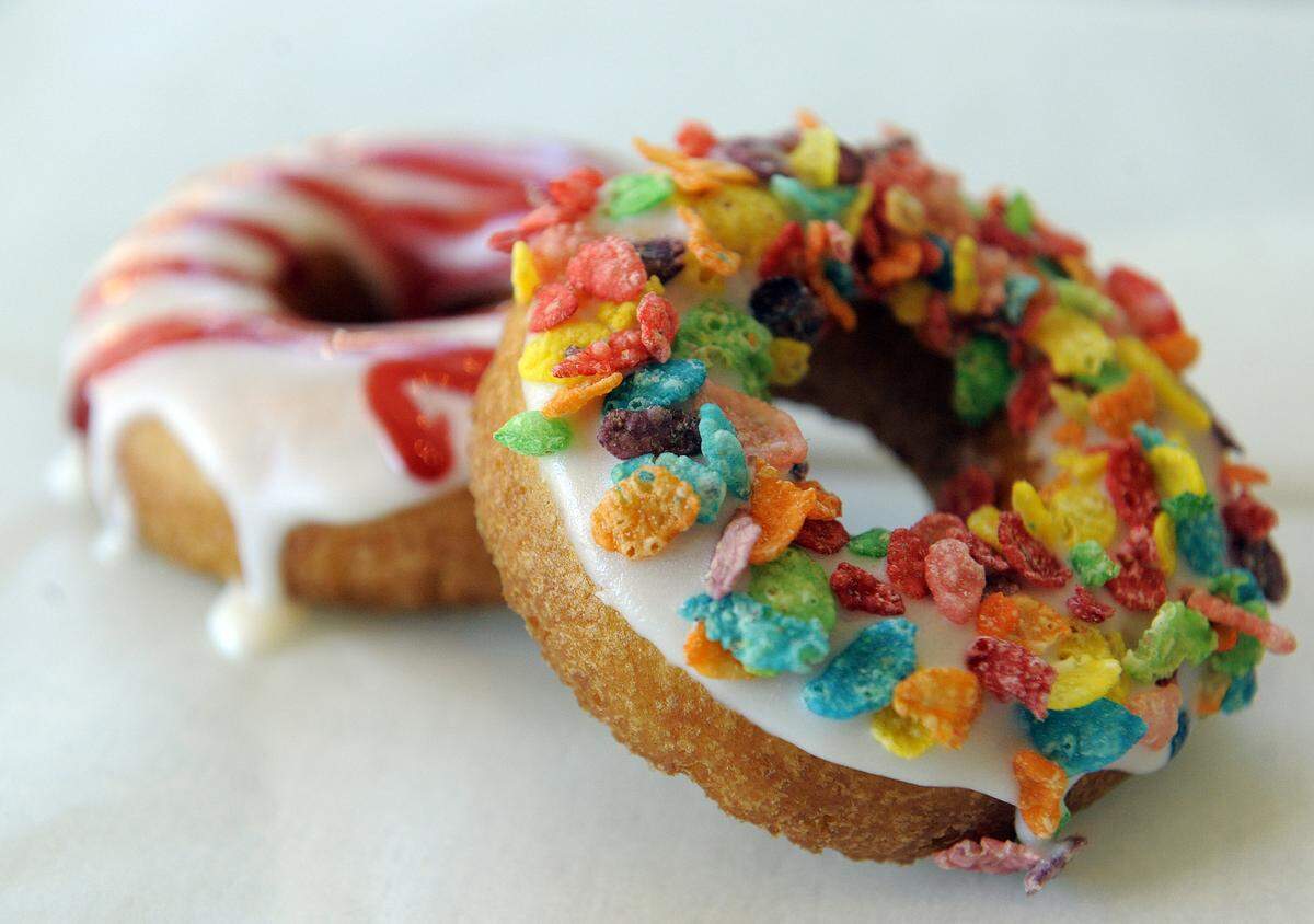 Customers can customize fresh doughnuts with glazes and toppings at The Donut Experiment on Anna Maria Island.