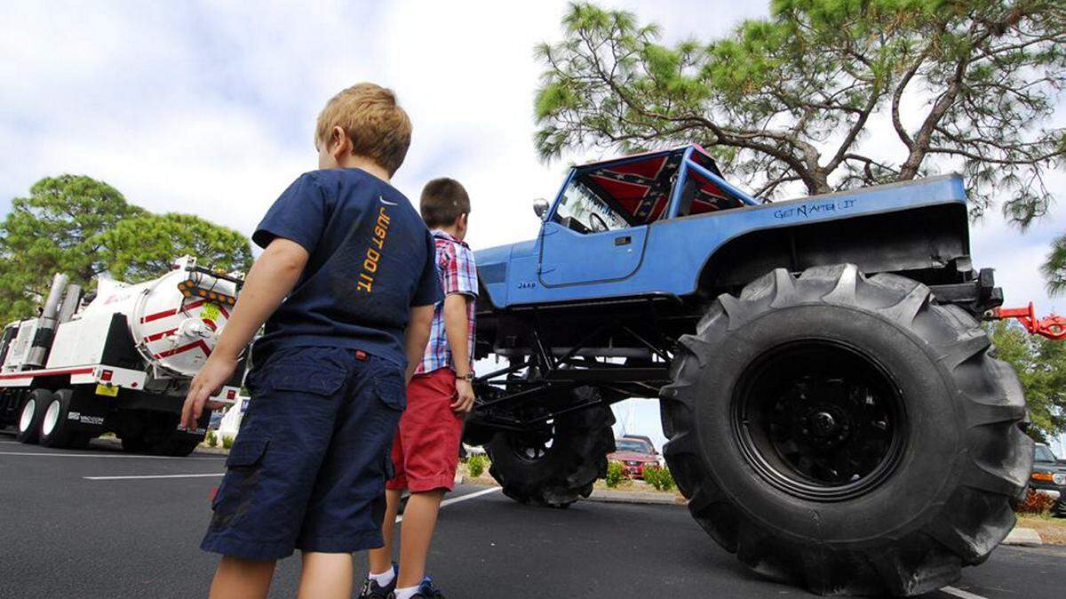 Children look at a monster truck at last year's Touch-a-Truck event at the Central Library. This year's event will be from noon to 3 p.m. Saturday. 
 PHOTO PROVIDED