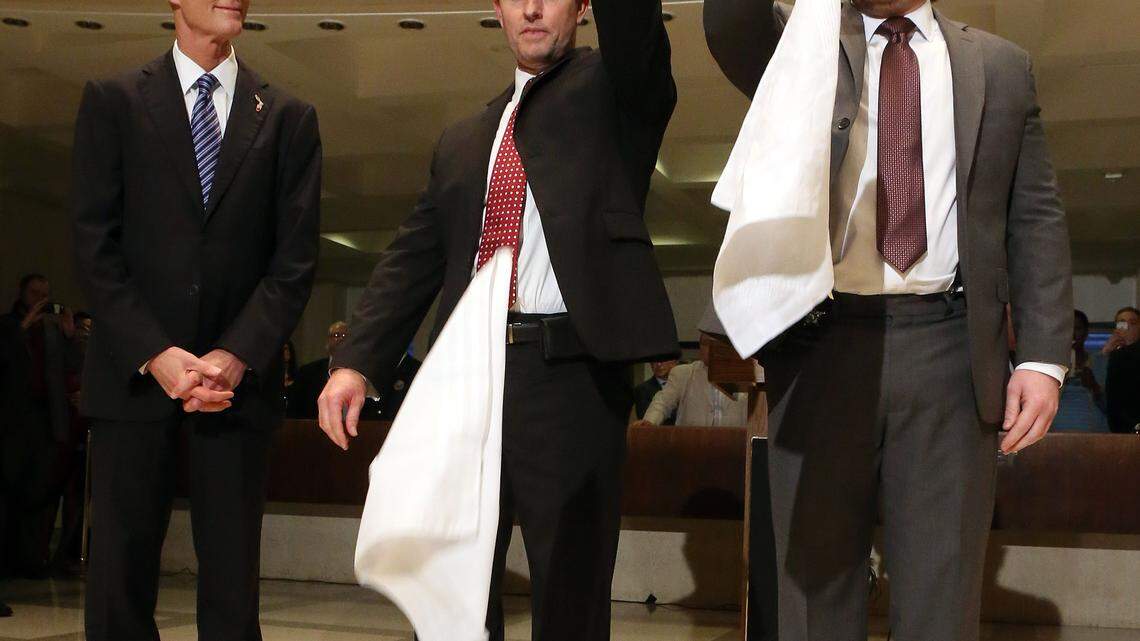 Gov. Rick Scott, from left, watches Friday as Sergeant of Arms of the House, Russell Hosford, and Senate, Tim Hay, perform a ceremonial hankie drop to end session in Tallahassee. 
 STEVE CANNON/Associated Press