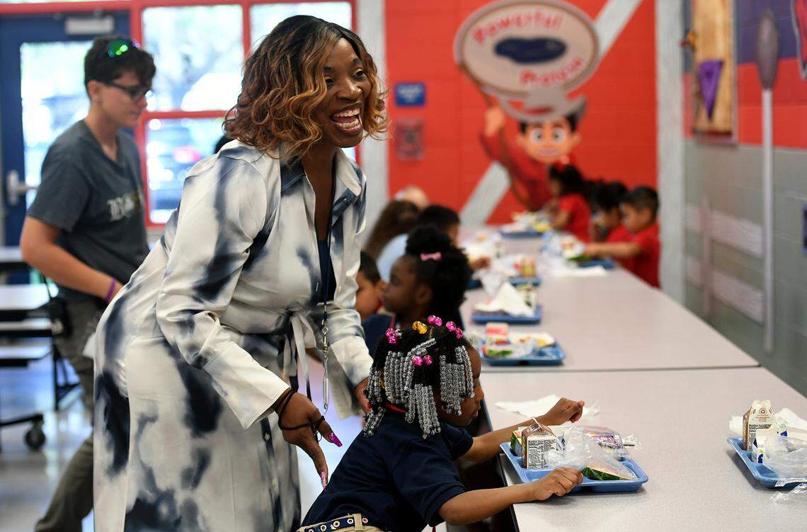Vanessa Goldsmith, Manatee Elementary School’s Graduation Enhancement Technician, helps her granddaughter, Toniyah McDaniels, 5, with her lunch in the cafeteria.