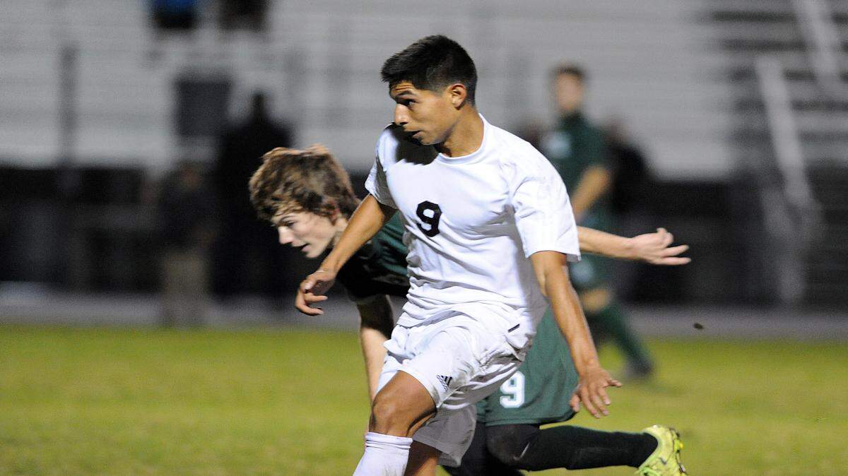 Palmetto's Ben Espinal keeps the ball from Venice's Austin Streich in the district 4A-11 semifinal at Palmetto against Venice Wednesday night. 
 TIFFANY TOMPKINS-CONDIE/Bradenton Herald