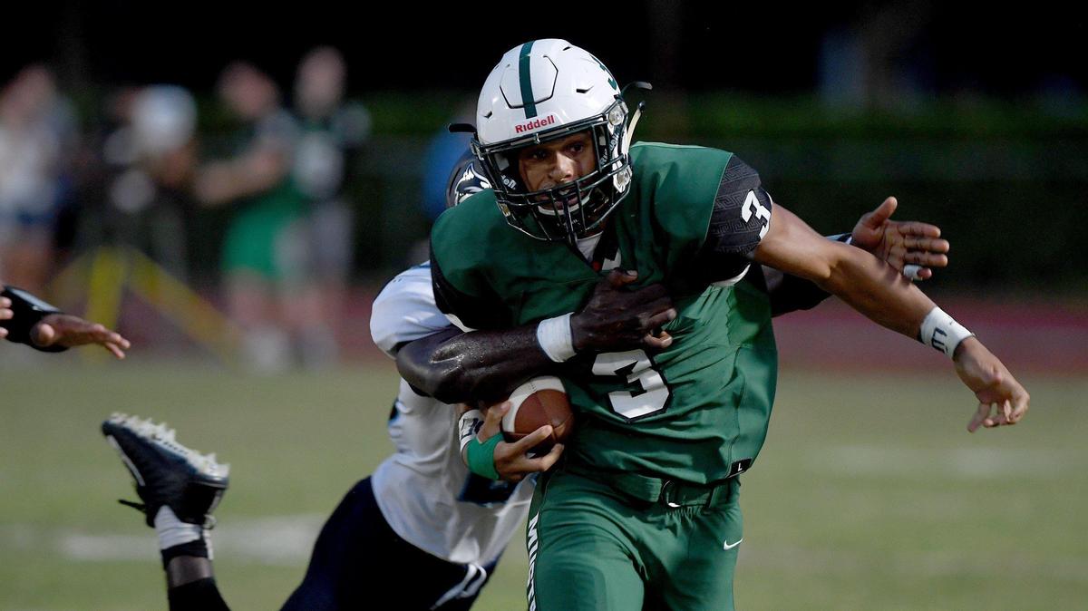 Lakewood Ranch’s Isaiah Harrison tries to break free from a tackler during the Mustangs’ Week 4 overtime win against North Port.