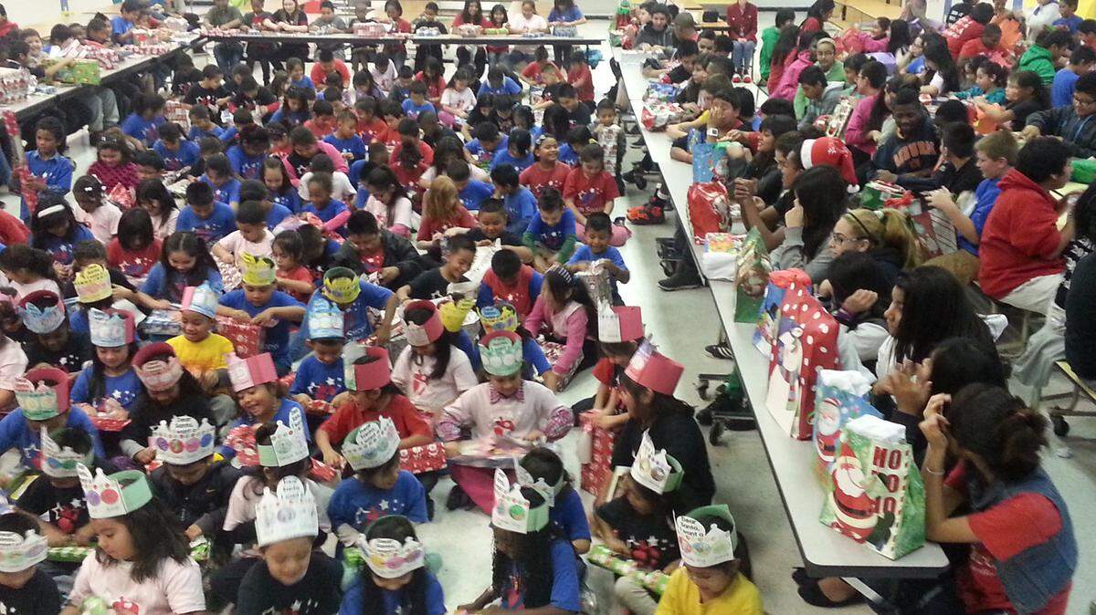 Team Success charter school students celebrate during a holiday gift-giving bash. With increased enrollment, the school is looking for more partners to help make sure each child has at least one gift. PHOTO PROVIDED