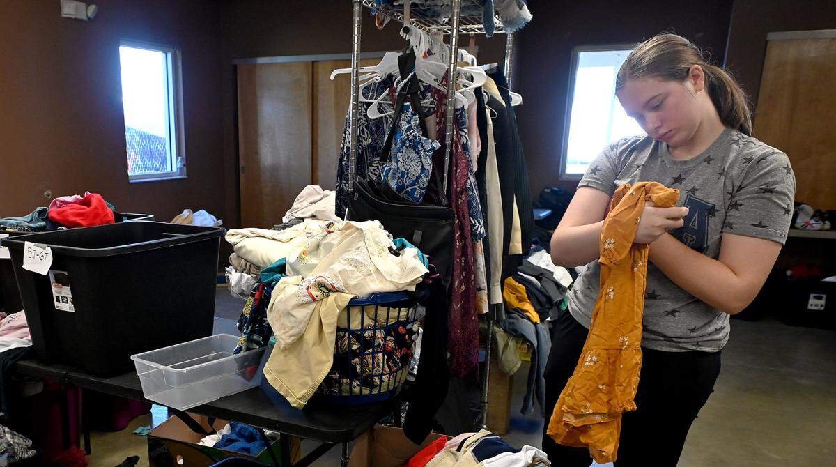 Hannah Keen, 16, goes through clothing for families impacted by Hurricane Ian at the Myakka Community Center October 7, 2022.