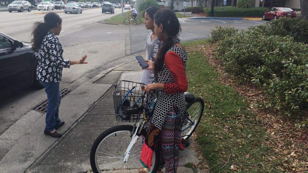Farjana Thahrin, 18, stands beside her mother's bicycle after a crash Friday afternoon. Thahrin's mother was riding her bicycle across the lanes of Cortez Road near Fifth Street West in Bradenton when she was hit by a car. She was transported to Manatee Memorial Hospital. 
 AMARIS CASTILLO/Bradenton Herald