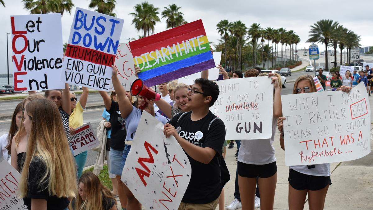 Ahmad Ibsais (middle), a 17-year-old senior at Braden River High School, rallies more than 100 people with a megaphone during the March For Our Lives in downtown Sarasota on Saturday morning.