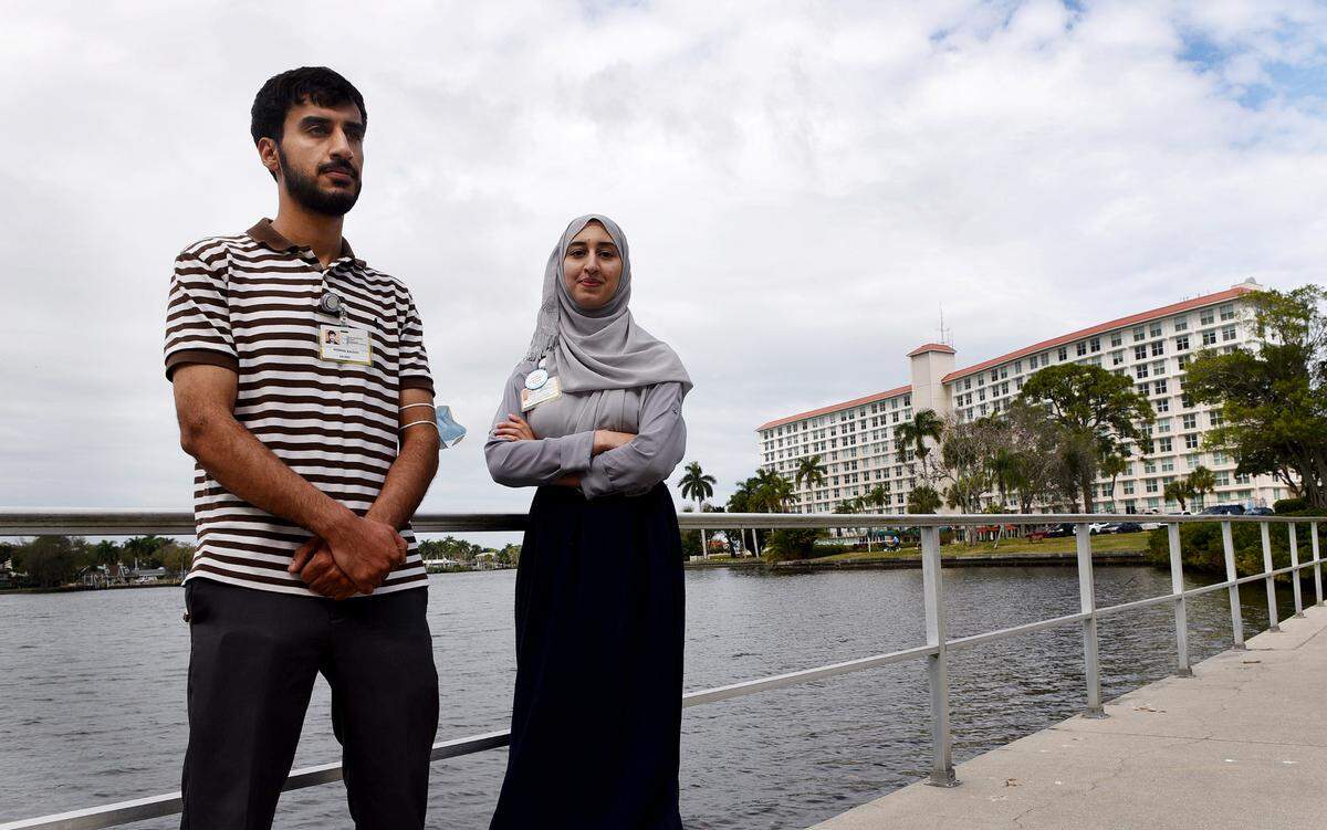 Noman Raoufi and his sister, Venus, at Westminster where they both now work after immigrating from Afghanistan.