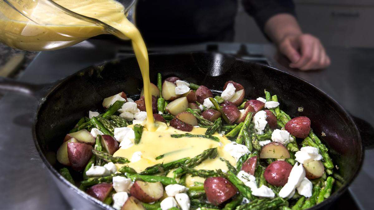 Pour fresh eggs beaten with cream or milk over frittata filling. TNS