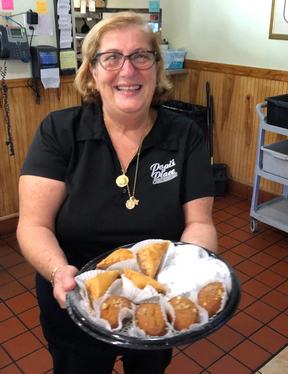 Popi Ameres promises there will be lots of pastries served at Greek Night. She is shown with a platter of baklava.