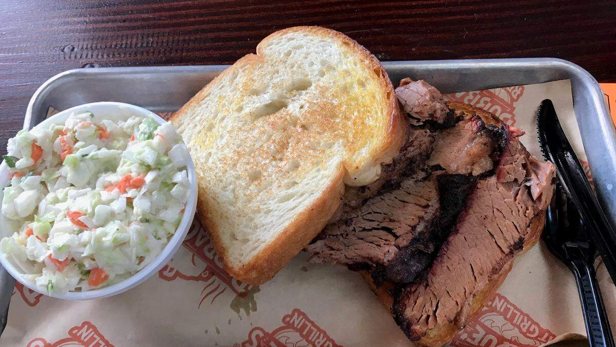 The Texas Brisket sandwich, shown above with a side of coleslaw, is one of the offerings at BubbaQue’s restaurant, 6581 State Road 70 E., next to Zaxby’s.