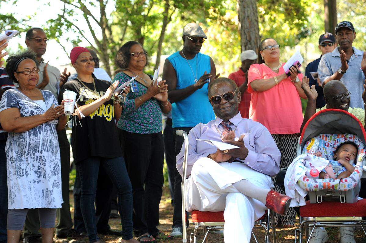 Clarence Love, once a Bradenton City Councilman, smiles and claps with the gathering at the re-opening of Love Park, named in his honor, during a celebration in May 2014.