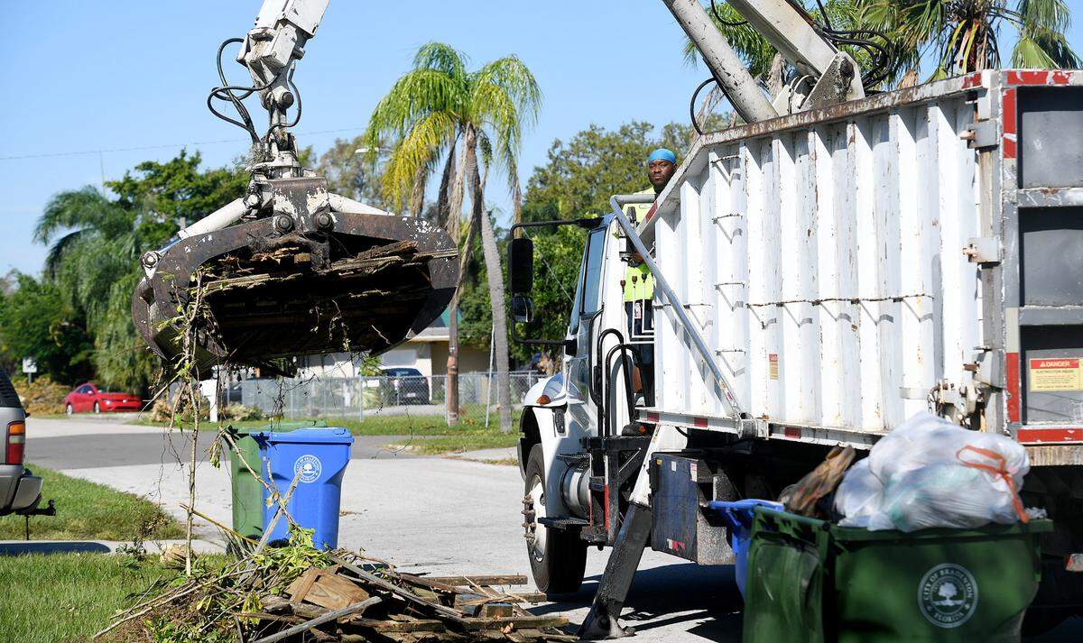 A City of Bradenton truck picks up what appears to be damaged fencing material as the area cleans up from Hurricane Ian in West Bradenton on October 3, 2022.