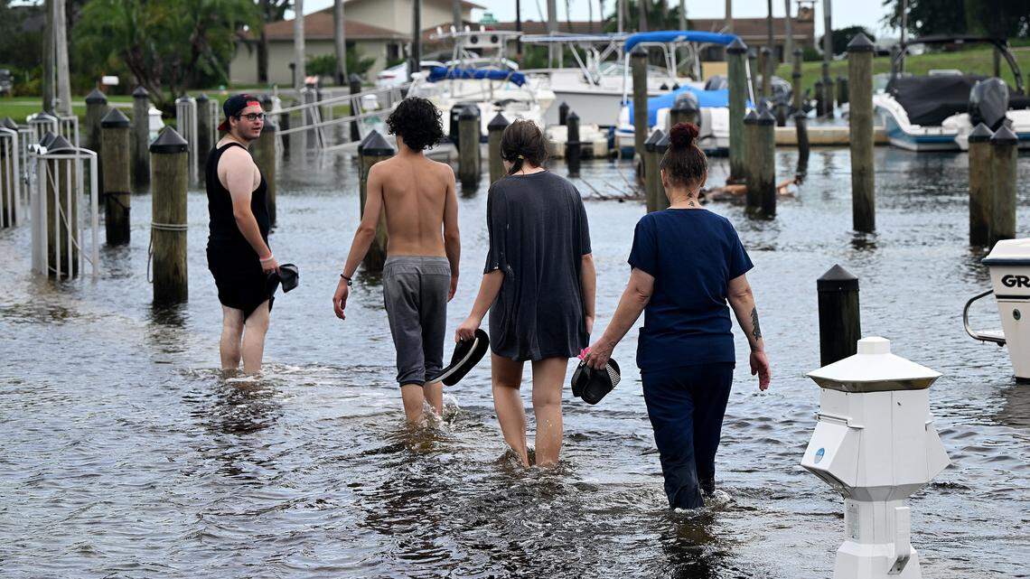A group of young people wade through the waters at Portosueno Park in the Bradenton area after Hurricane Idalia passed on August 30, 2023.