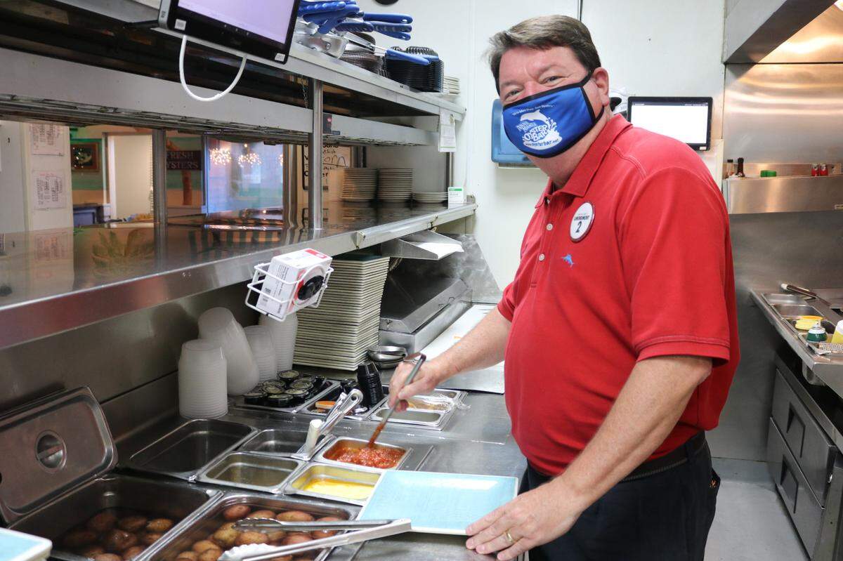 John Horne, owner and CEO of Anna Maria Oyster Bar, is marking 25 years of building the local restaurant brand. He is show above stirring the marinara sauce.