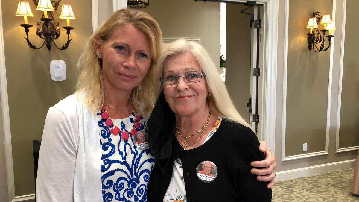 4/28/2021--Jeanne Grose, left, and Joanne Sternberg wore buttons with the photo of Wayne Sternberg, who died early in the pandemic from COVID-19, to a scholarship luncheon this week. Joanne also wore her husband’s watch and a ring to the program which awarded scholarships to nursing students.