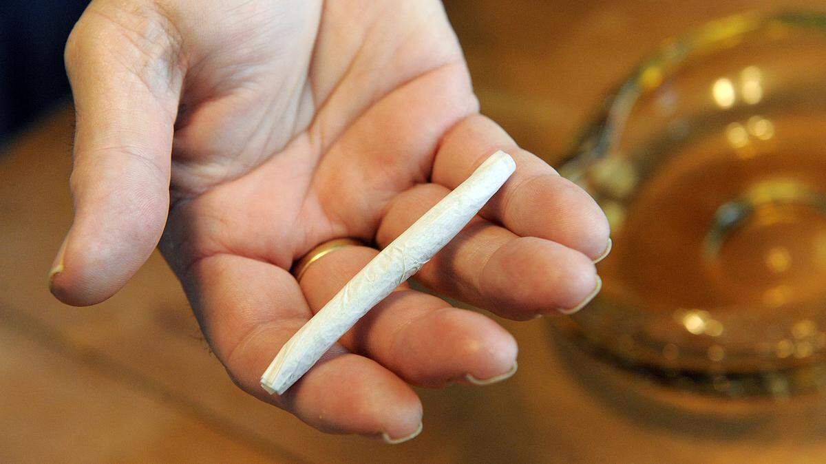 File photo of a Florida man holding a marijuana cigarette. Medical marijuana has been legalized in Florida.