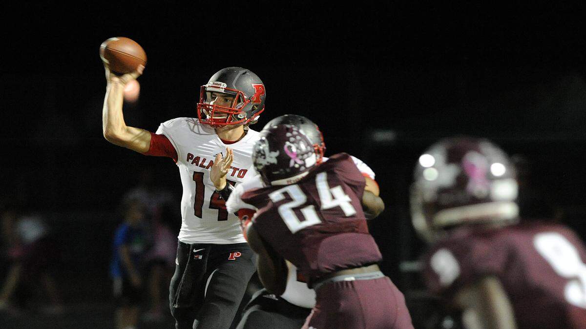 Palmetto's Jack Allison readies to throw a pass Cedrick Waters during a game in October at Braden River. 
 TIFFANY TOMPKINS-CONDIE/Bradenton Herald file