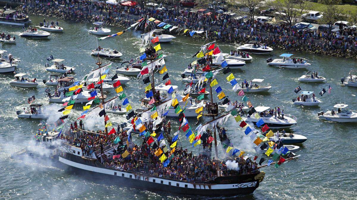 The Jose Gasparilla makes its way along Seddon Channel in Tampa with hundreds of pirates aboard, as a flotilla of boats follows to kick off a past Gasparilla pirate invasion. ASSOCIATED PRESS