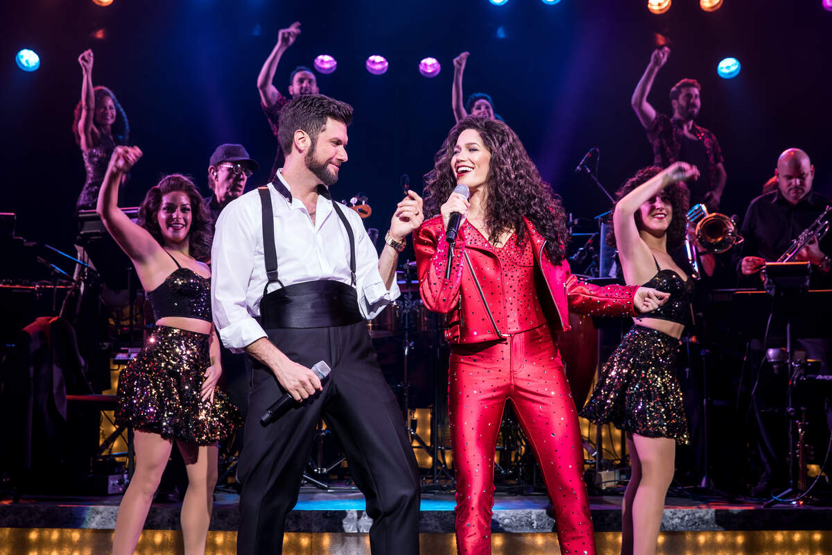 Mauricio Martinez as Emilio Estefan and Christie Prades as Gloria Estefan and company perform in “On Your Feet!”