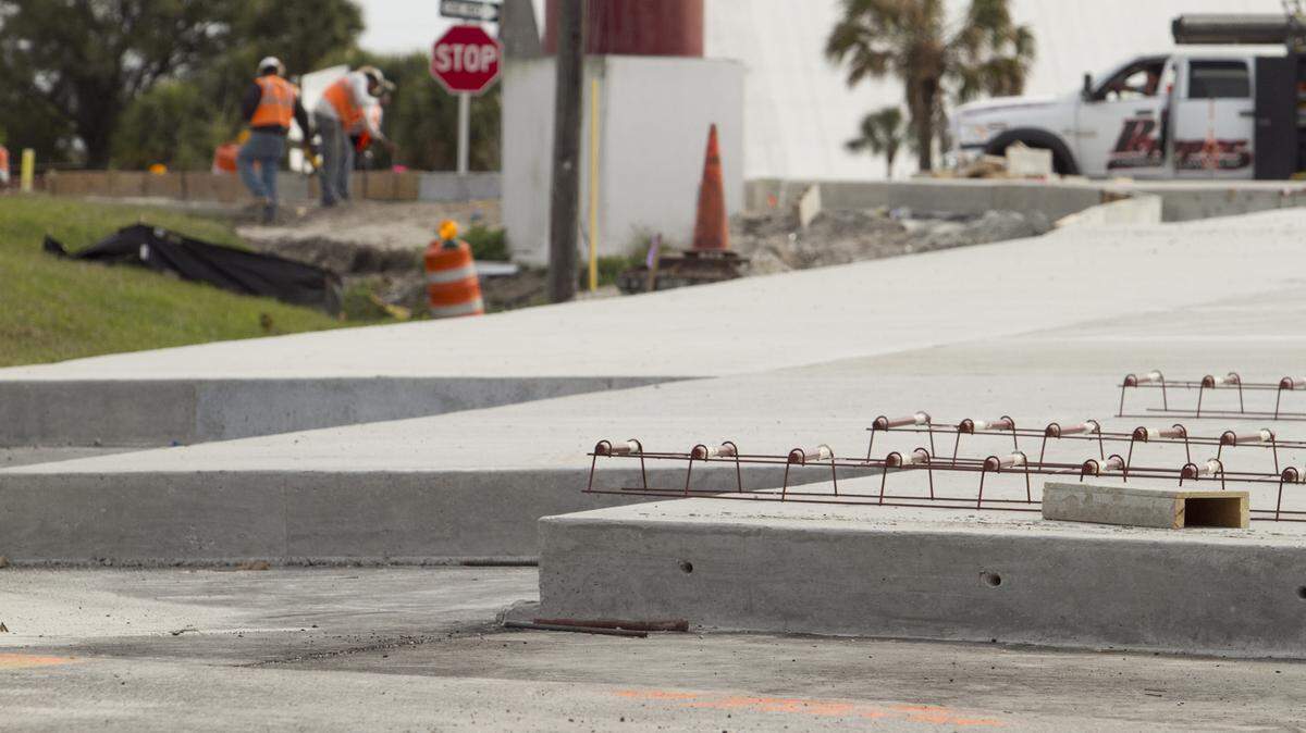 A road construction crew works near where a Florida Department of Transportation project installed heavy-duty concrete paving at the entrance of Port Manatee over the last few weeks. The work is part of a road reconstruction project on 5 miles of U.S. Highway 41 between Interstate 275 and the Hillsborough County line. MATT M. JOHNSON/Bradenton Herald