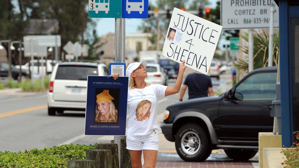 Kelly Osborn protests in front of Bradenton Beach City Hall the closed investigation and findings of the Bradenton Beach Police into the death of her daughter, Sheena Morris, who was found dead in the shower of a motel in 2009. Osborn believes there is evidence that her daughter was murdered and the that the investigation was botched.
