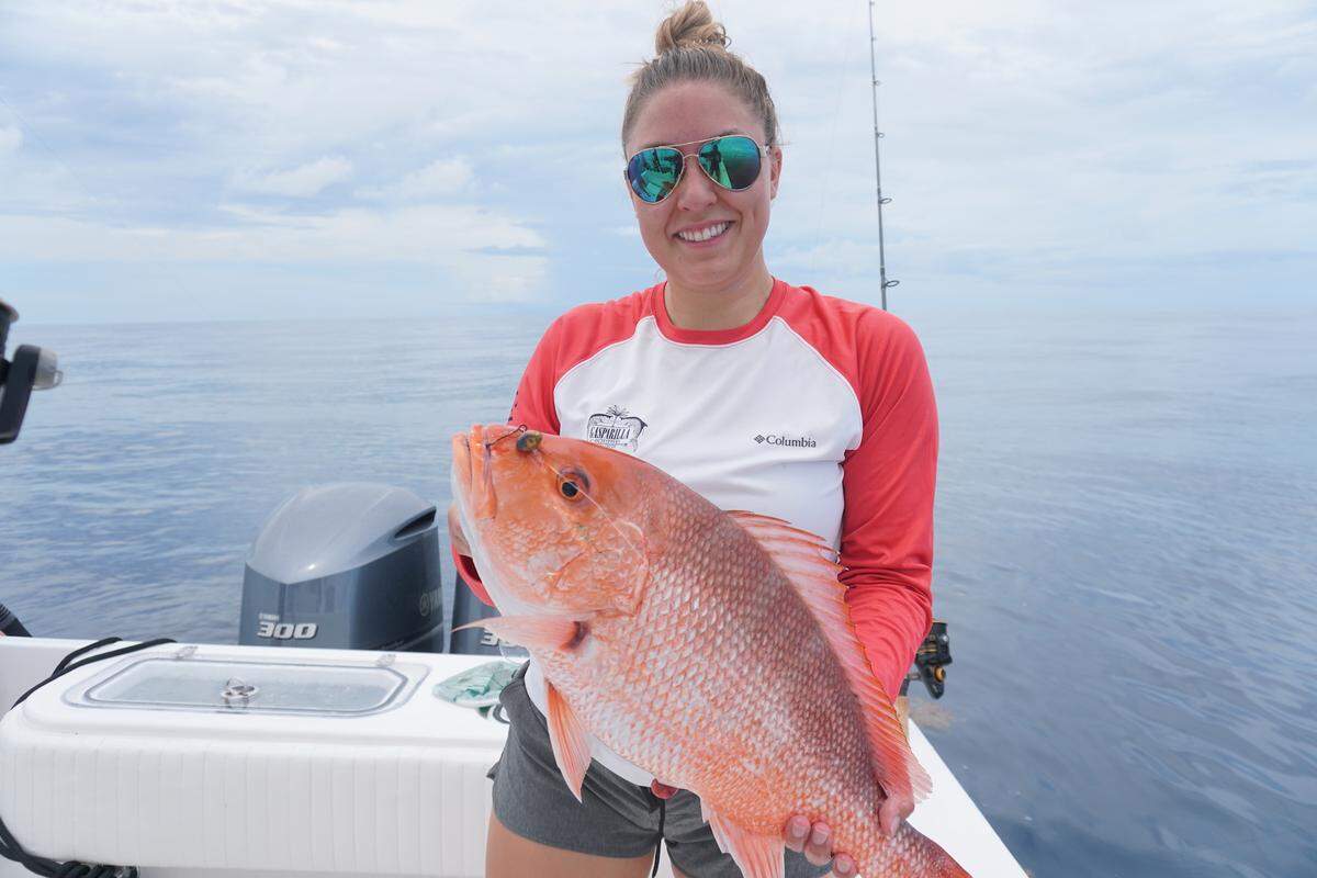 Danielle Ellis proudly displays a red snapper caught in the Gulf of Mexico.
