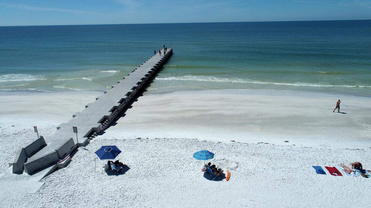 After Hurricane Ian bathers enjoy the sand and waters of Cortez Beach on October 3, 2022.