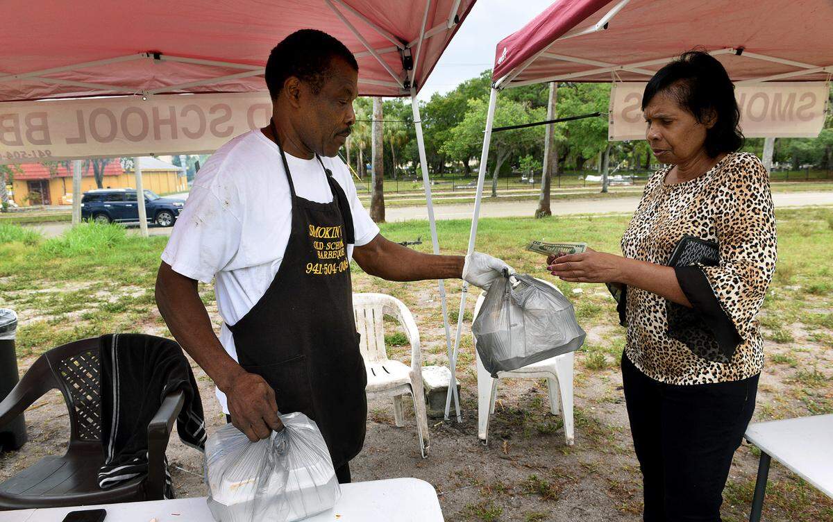 Darryl Fields of Smokin’ D’s Old School BBQ cooks chicken and ribs on Fridays and Saturdays. You can pick up his smoky homemade BBQ or macaroni and cheese and potato salad in the 500 block of MLK Blvd. in Bradenton. Altamease Edwards pays for her order on Friday morning.
