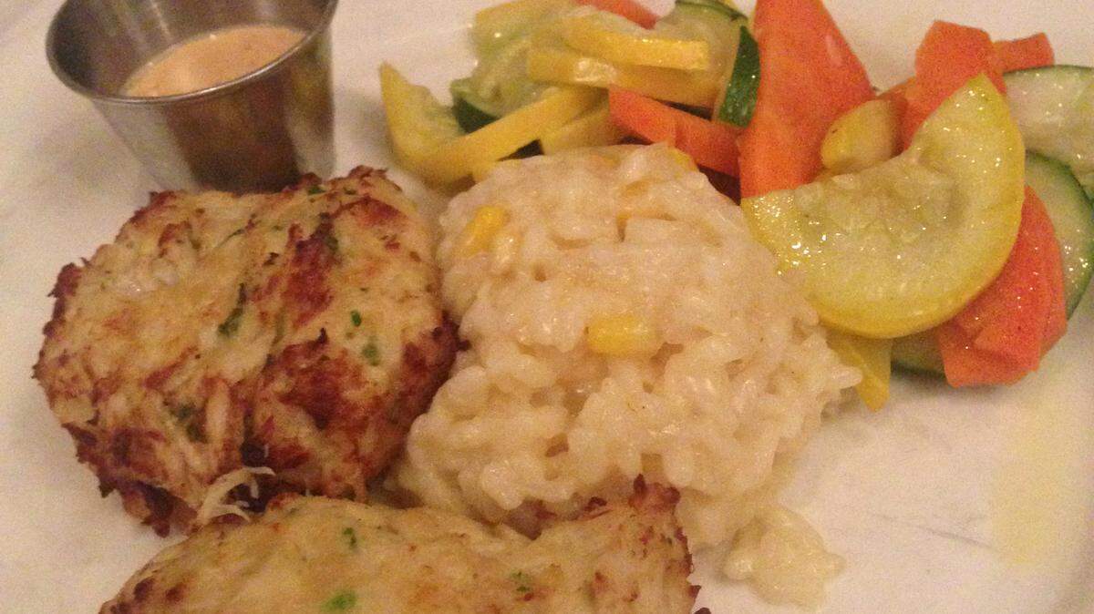 Crab cakes are served with corn risotto and mixed vegetables at Pier 22 in downtown Bradenton. 
 JANA MORREALE/Bradenton Herald