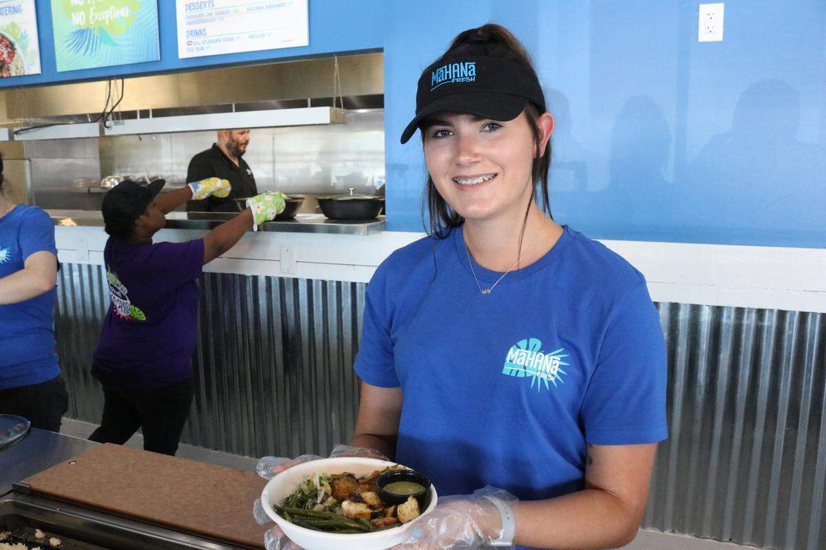 Brooklyn Eliseo serves up a freshly made bowl at Mahana Fresh, 4808 14th St. W.