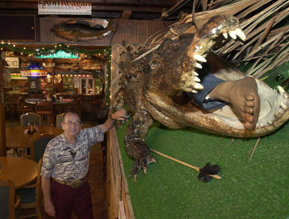 Frank Gamsky, beside a 12 foot 2 inch allagator on display in the dining room at Linger Lodge in east Manatee County. Photo Jefferies 6-12-02
