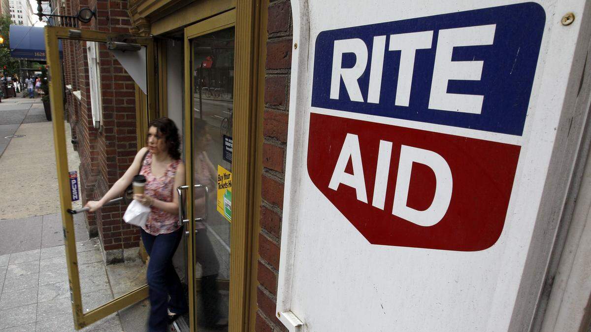 AP FILE PHOTO - In this June 20, 2011, file photo, a woman exits a Rite Aid store, in Philadelphia.