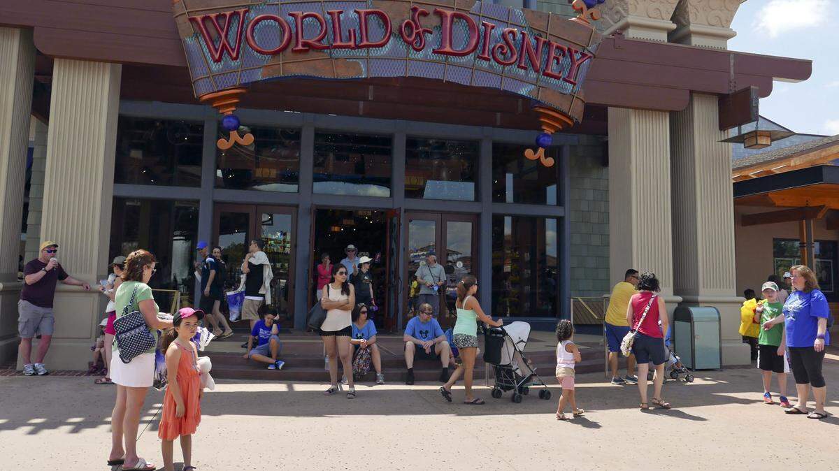 Last Friday, visitors stroll by the World of Disney store at Disney Springs in Lake Buena Vista. Florida tourism officials announced Monday the number of visitors coming to Orlando last year jumped 5.5 percent to more than 66 million visitors making the area the top tourist destination in the United States for the second year in a row. JOHN RAOUX/AP Photos