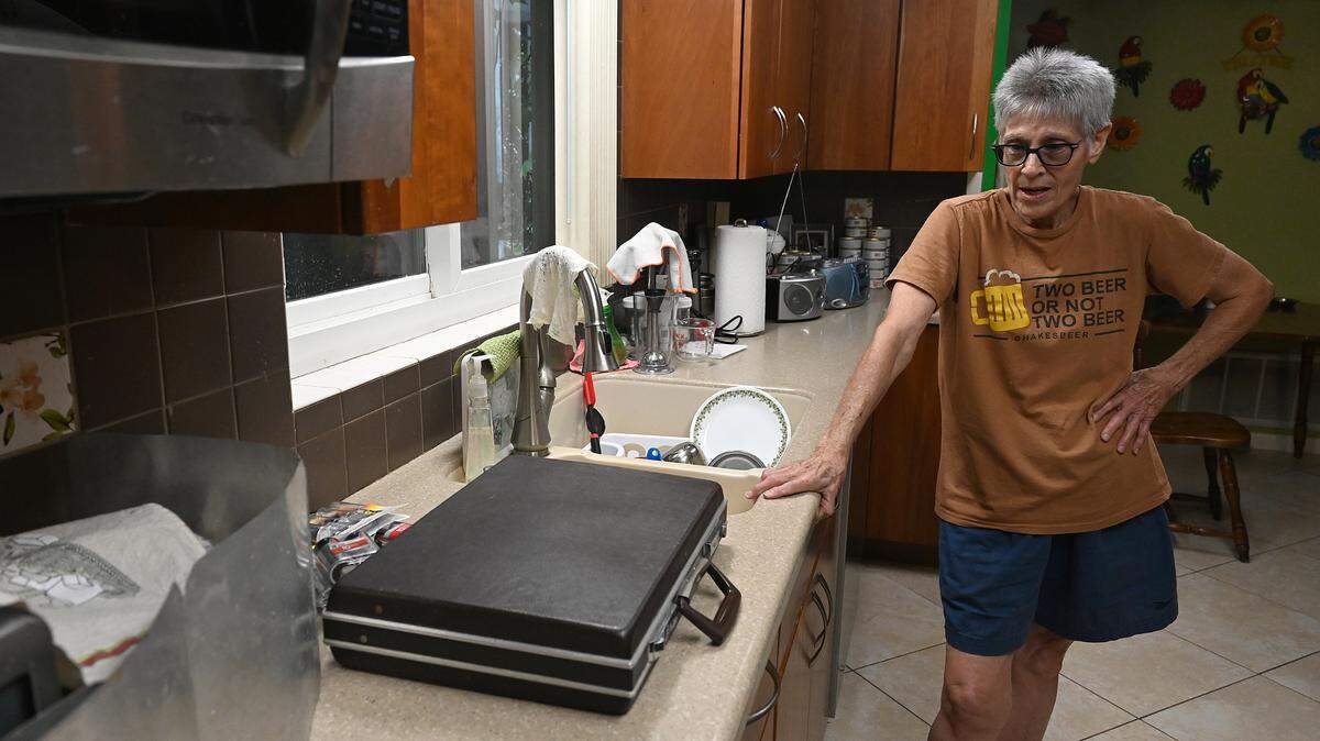 Marilee Bell has spent 38 years living in her Bradenton home and has decided to “hunker down” with her four cats as Hurricane Milton approaches Manatee County on Oct. 7, 2024. She has her briefcase full of important papers ready on the countertop in case she needs to leave.