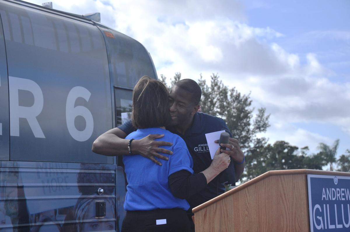 Tallahassee Mayor and the Democratic Party’s chosen gubernatorial candidate embraces Sheryl Wilson, the chairwoman of the Manatee County Democratic Party at the podium of Saturday’s campaign event.